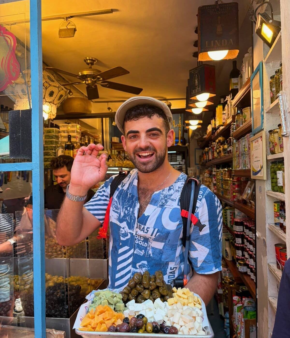 Yona Shemesh with a tasting platter in a Tel Aviv market shop
