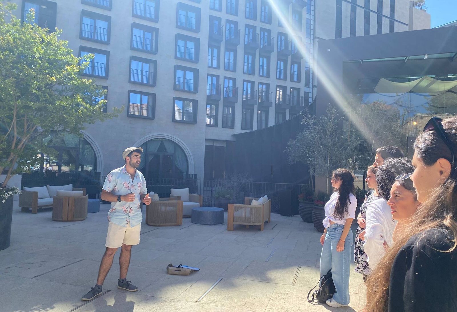 Yona Shemesh guiding a group in a Jerusalem courtyard