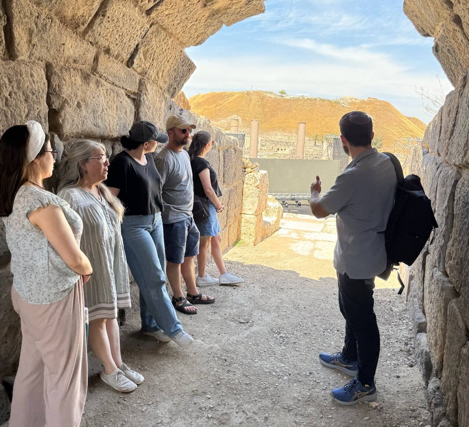 Yona Shemesh guiding a group through a vaulted passage at the Roman theatre of Beit She’an
