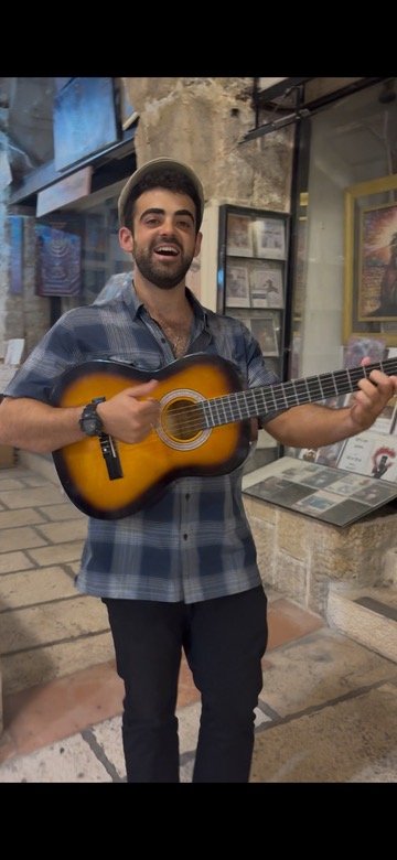 Yona Playing guitar on a Slichot tour in Ancient Jerusalem