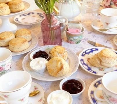 Scones, jam and tea on vintage china at Kumkum in Baka