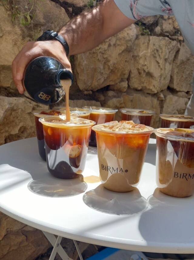 Iced coffee poured for a group mid-tour