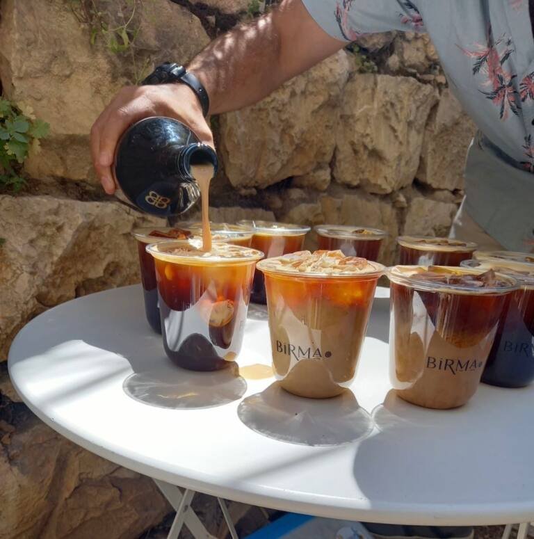 Iced coffee poured for a group mid-tour