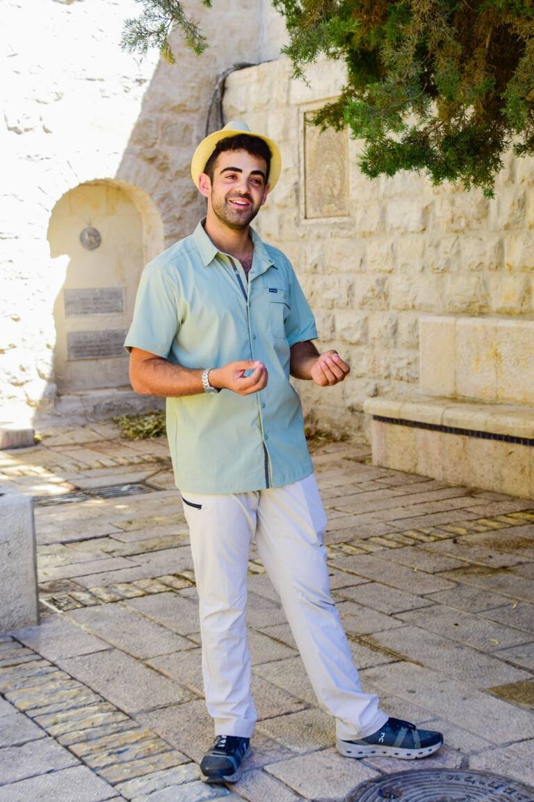 Yona Shemesh beneath a tree in a Jerusalem courtyard