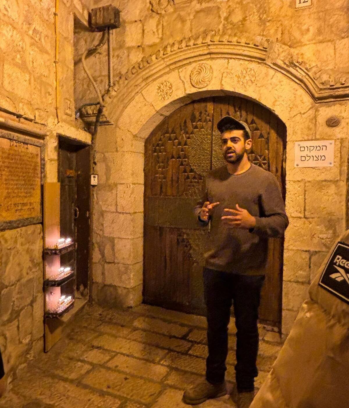 Yona Shemesh guiding in an Old City alley after dark