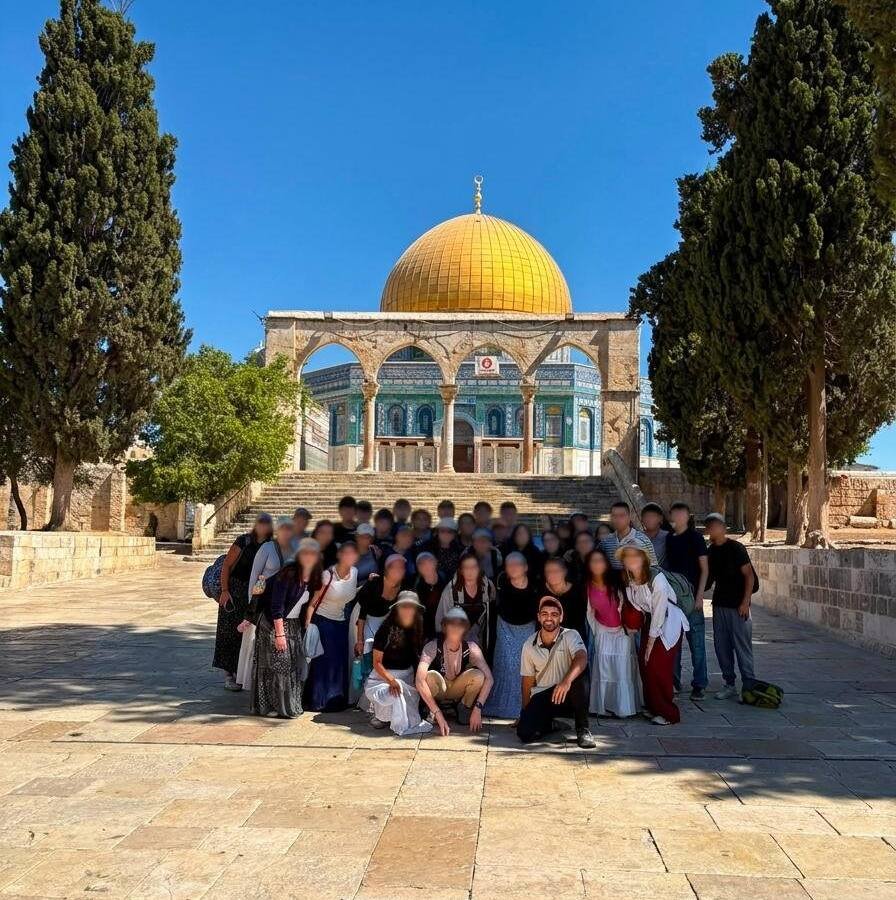 A tour group photographed on the Temple Mount in front of the Dome of the Rock