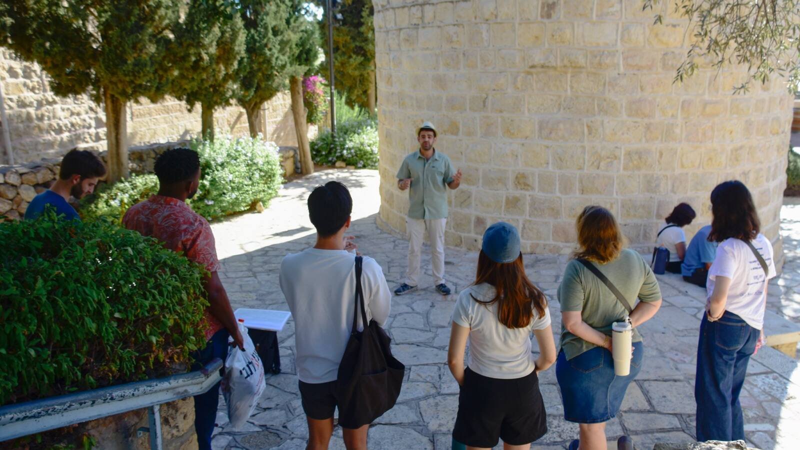 Yona Shemesh guiding a group beside the Montefiore windmill, Jerusalem