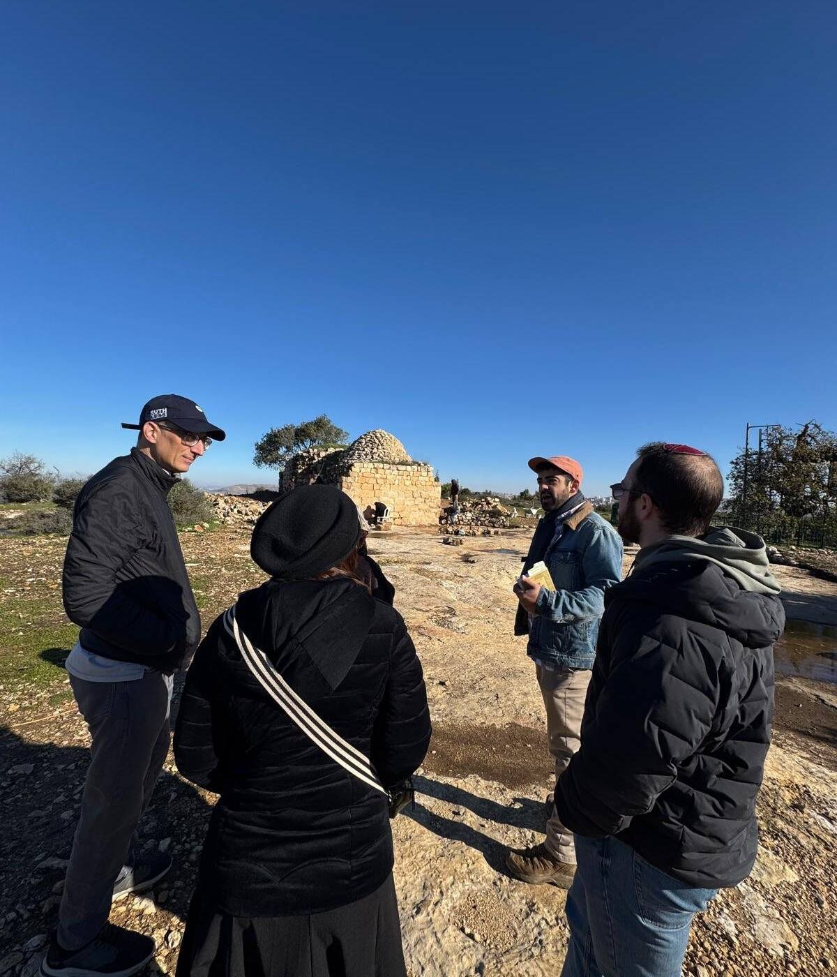 A tour group at a hilltop archaeological site in the Judean hills