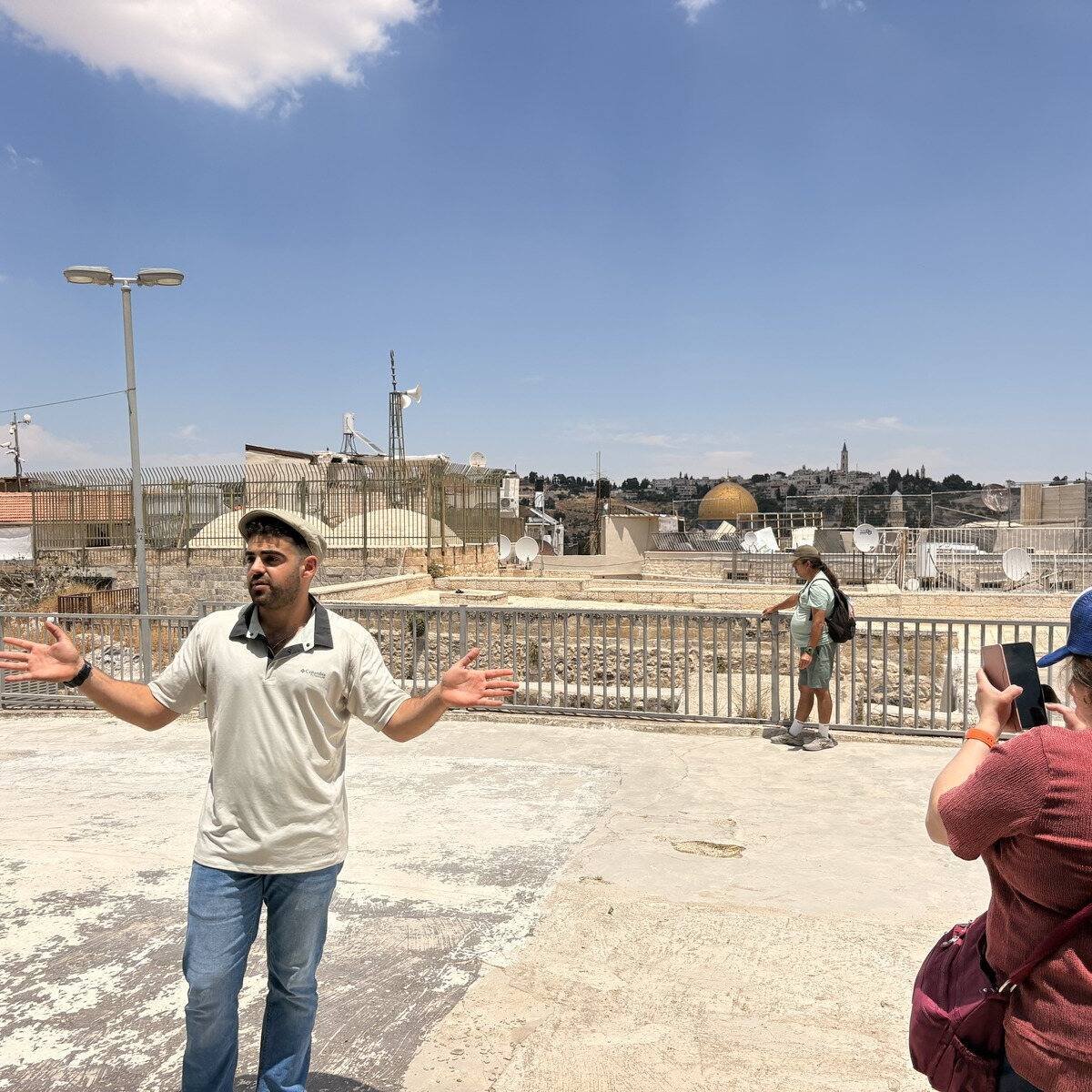 Yona Shemesh on an Old City rooftop with the Dome of the Rock behind him